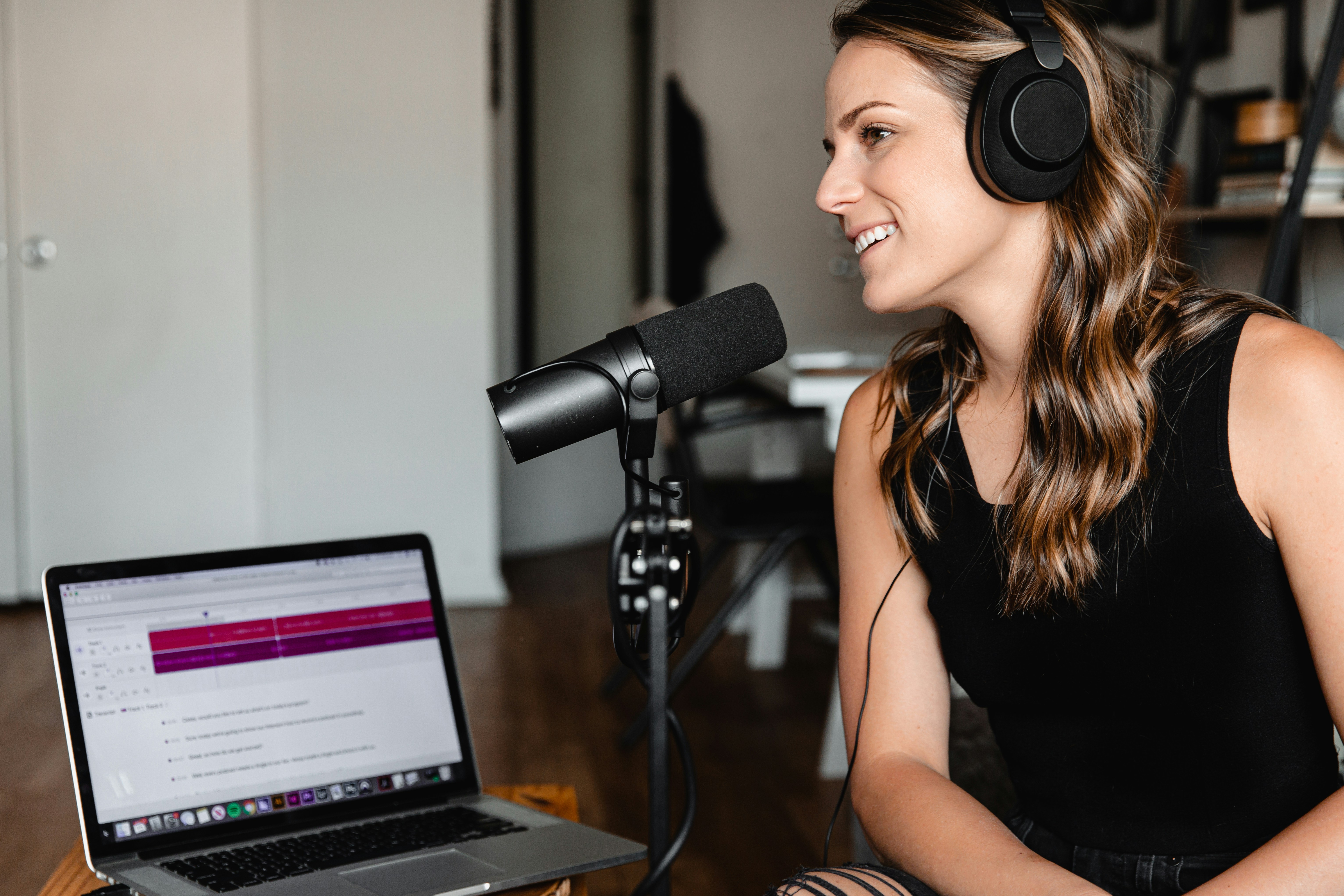 Woman recording a podcast in front of a microphone